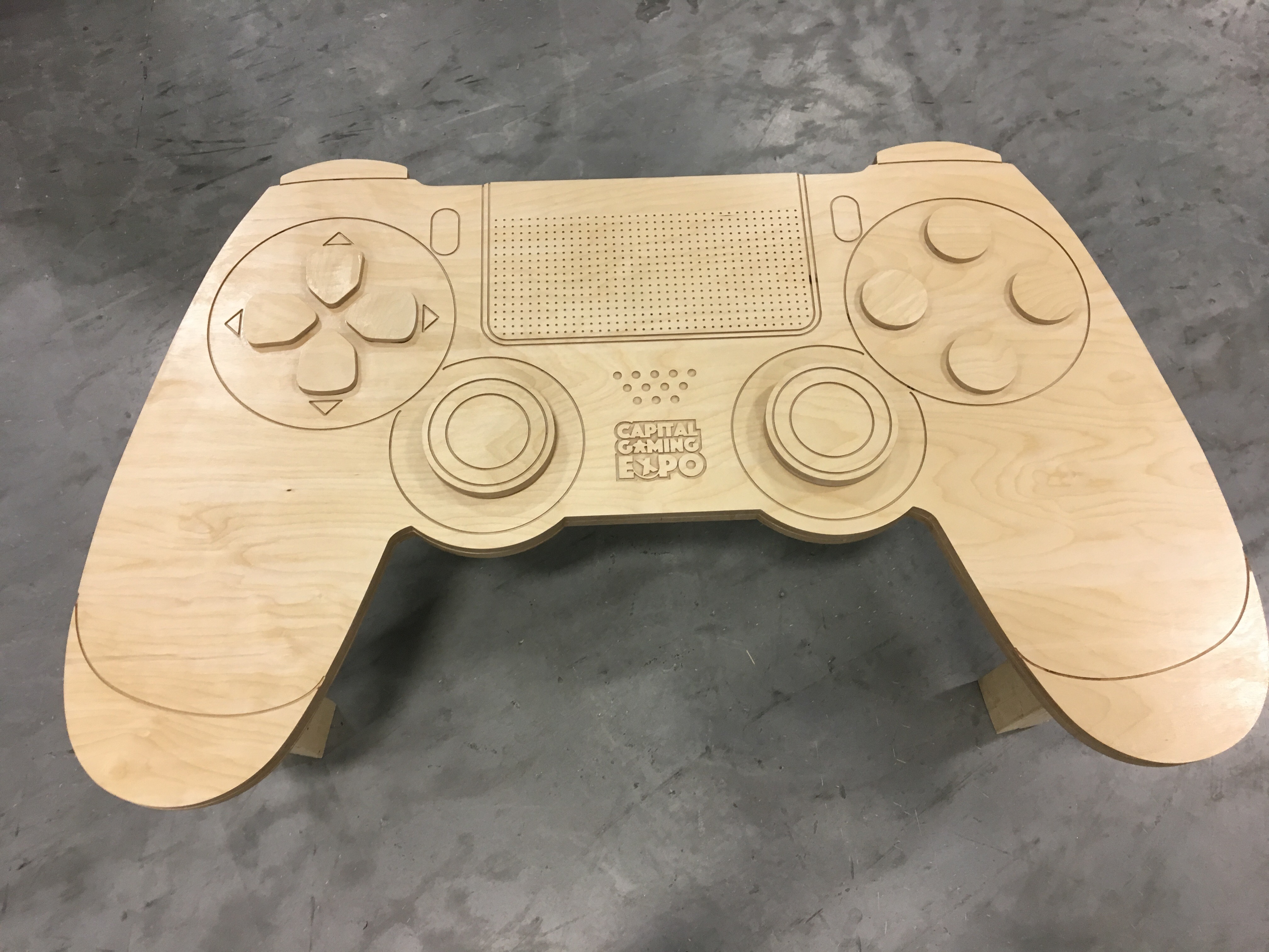 A plywood bench resembling a PS3 controller