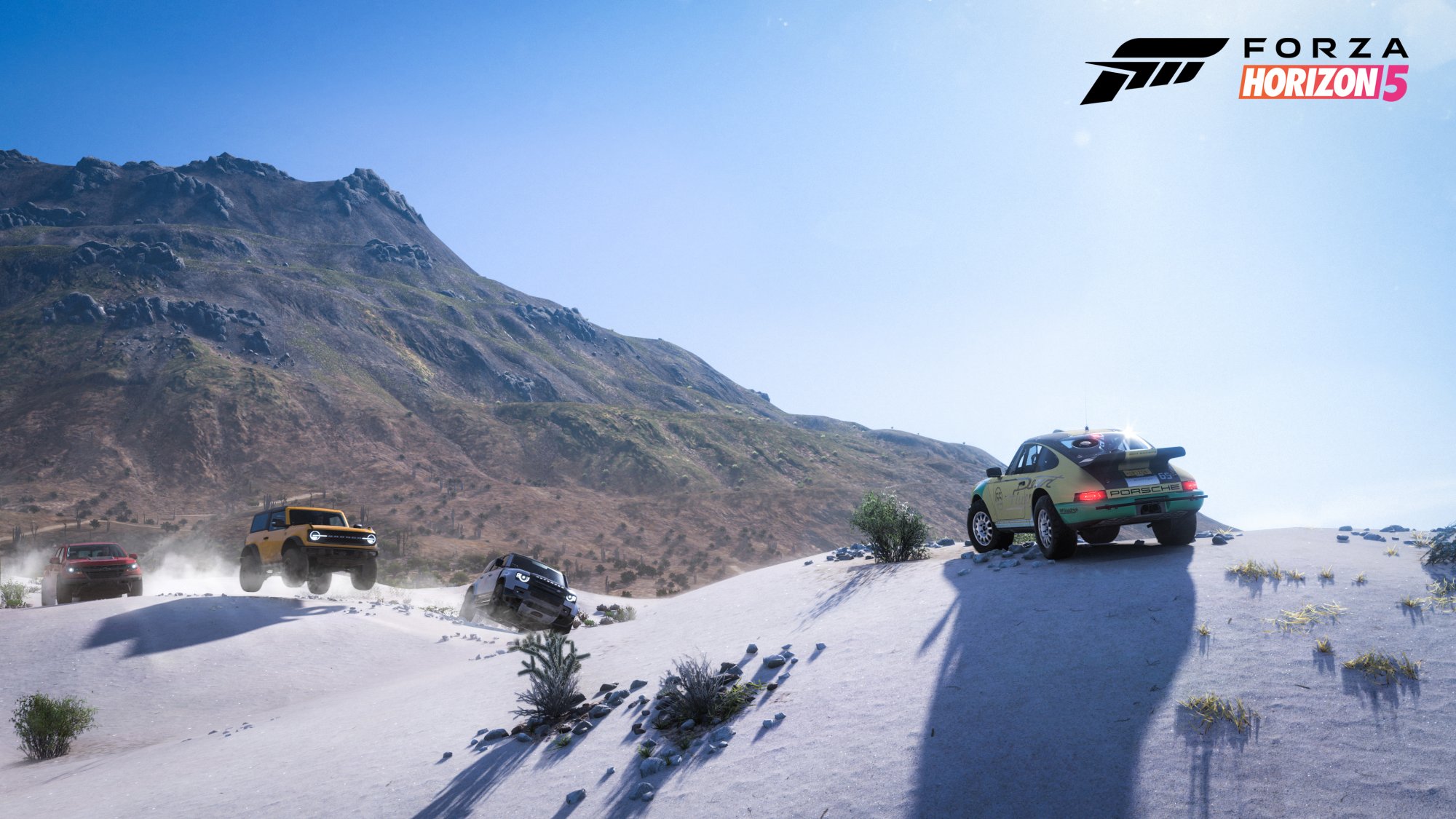 Marketing image for Forza Horizon 5 depicting a porsche cresting a sand dune facing down on coming SUVs.